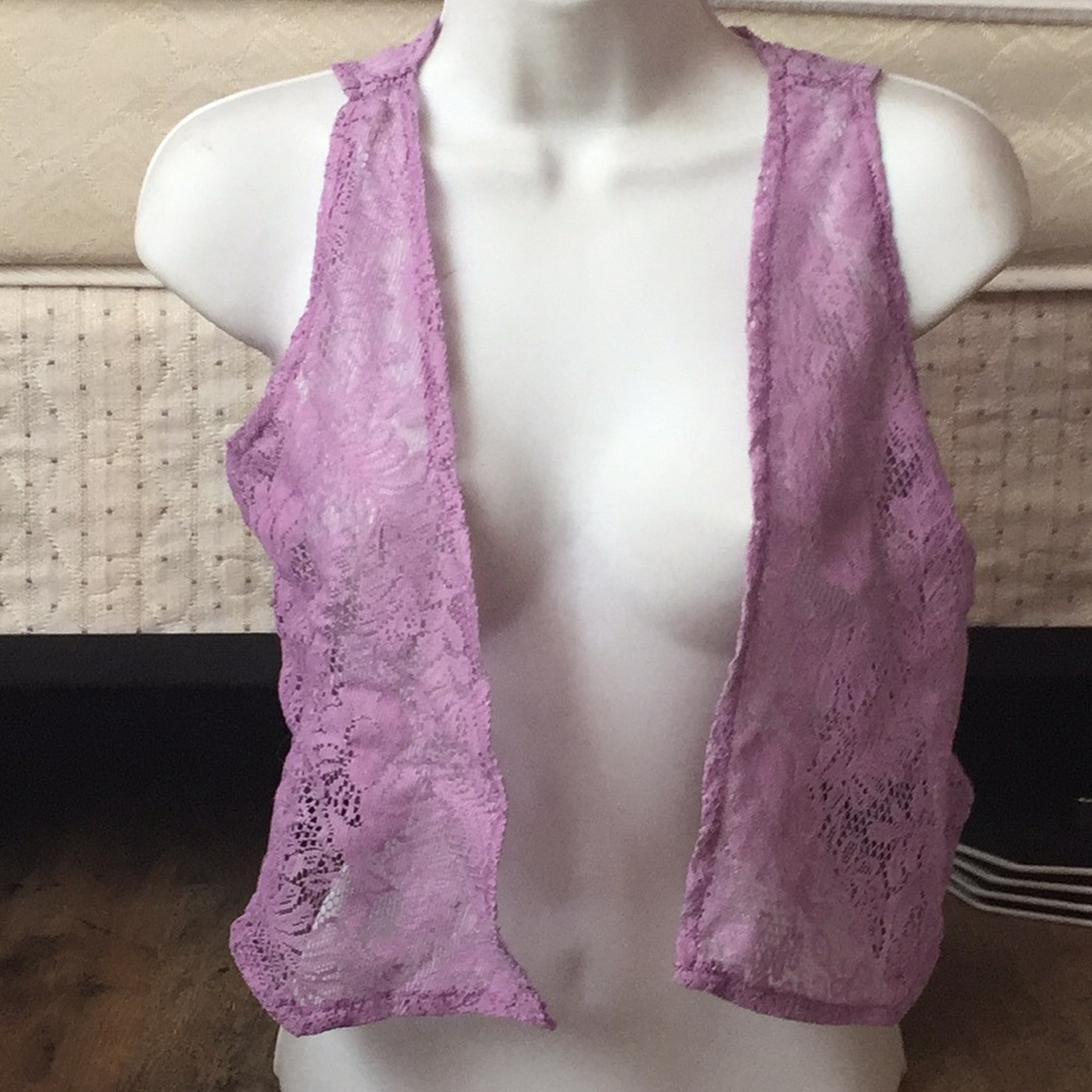 It is a purple cropped lace vest for kids